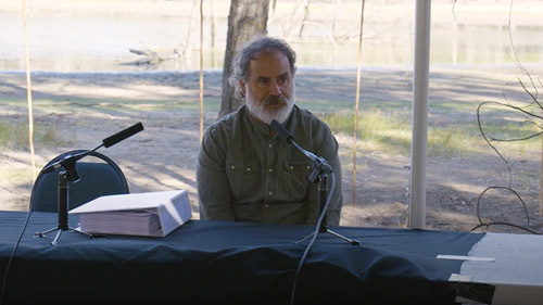 Uncle Brendan Kennedy presenting at a public hearing in front of a lagoon near Robinvale in Victoria