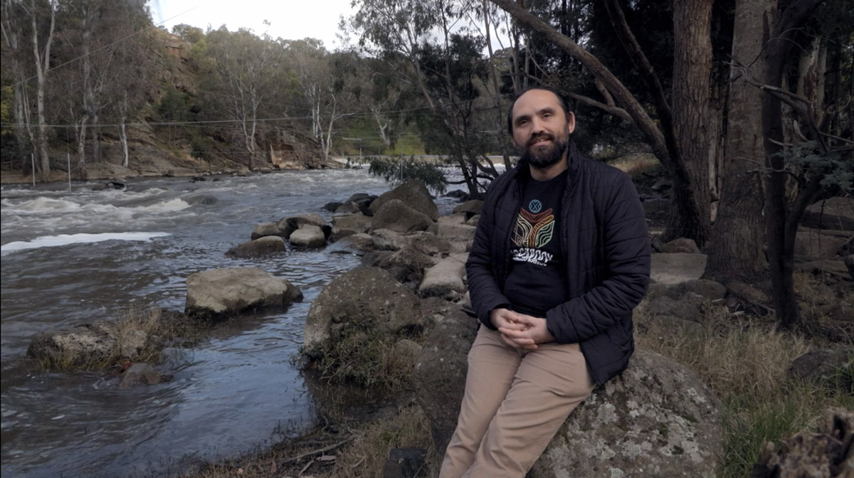 Truth receiver Stephen Thorpe sitting on a rock next to the Birrarung (Yarra river) at Dights Falls